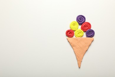 Photo of Ice cream cone madeplasticine on white background, top view