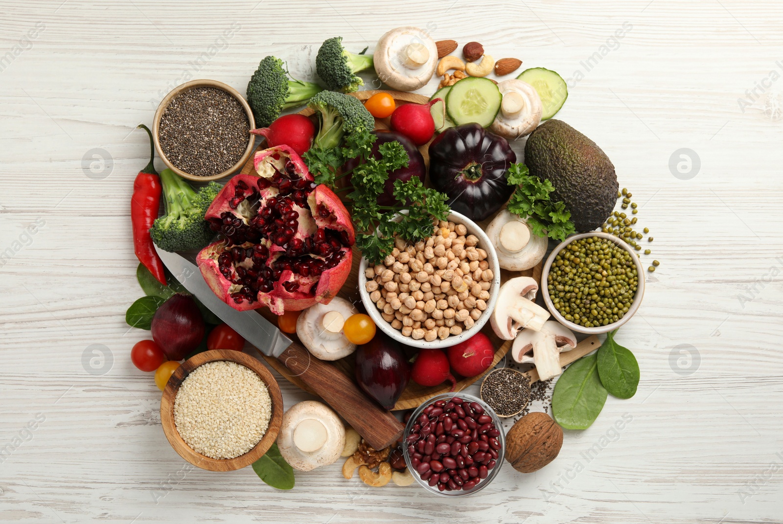 Photo of Different vegetables on white wooden table, flat lay. Vegan diet