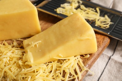 Photo of Grated and whole pieces of cheese on table, closeup