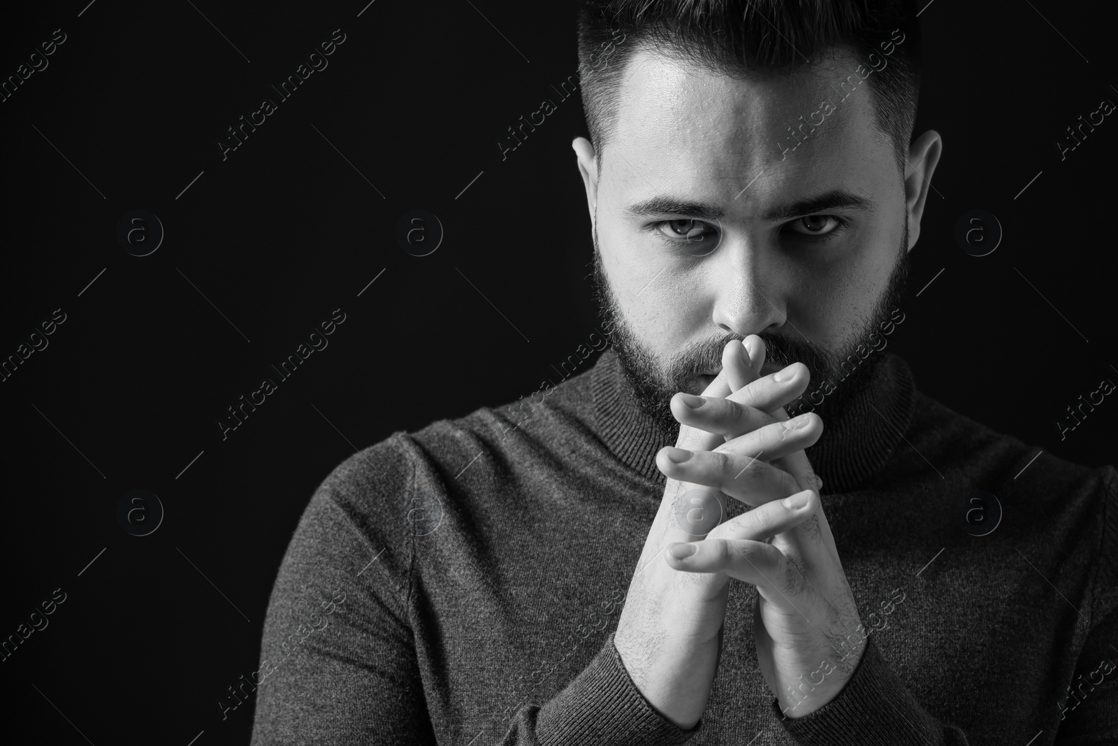 Photo of Portrait of handsome bearded man on dark background. Black and white effect