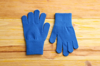 Photo of Stylish gloves on wooden background, flat lay