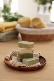 Photo of Soap bars on wooden table indoors, space for text. Spa time