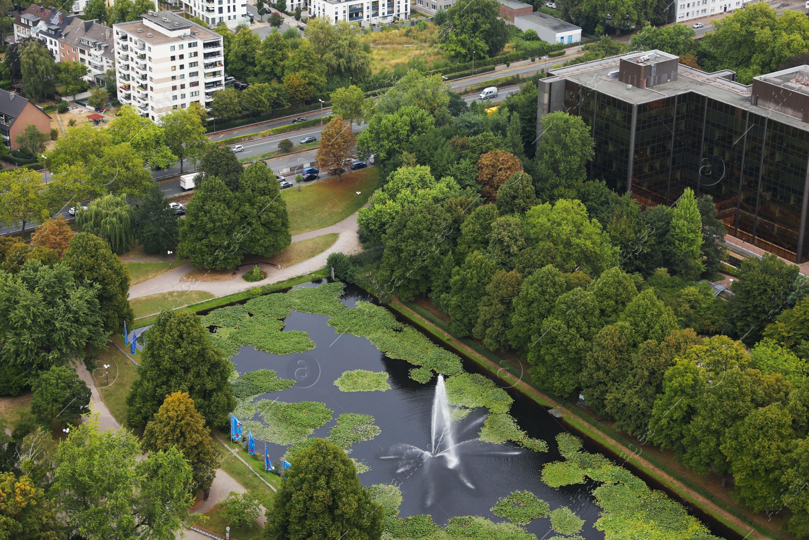 Photo of View of beautiful city with buildings, trees and fountain