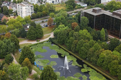 Photo of View of beautiful city with buildings, trees and fountain