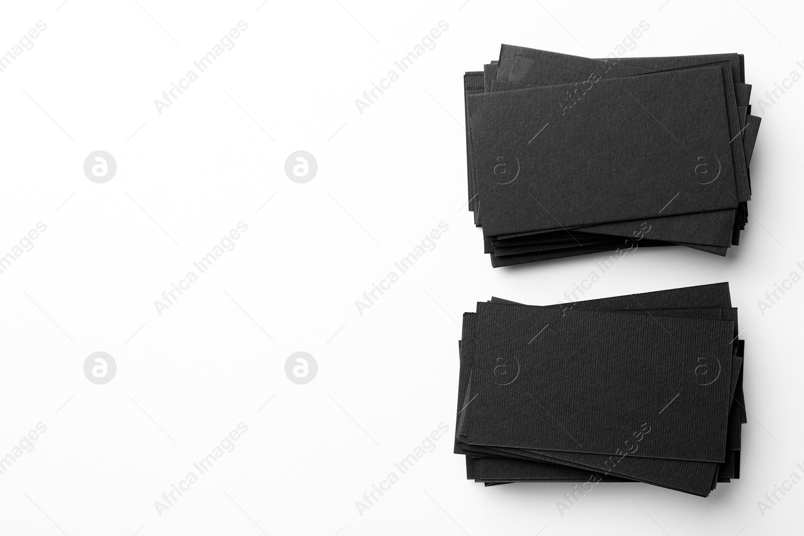 Photo of Blank black business cards on white background, top view. Mockup for design