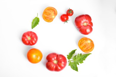 Photo of Frame of different ripe tomatoes and leaves on white background, flat lay. Space for text