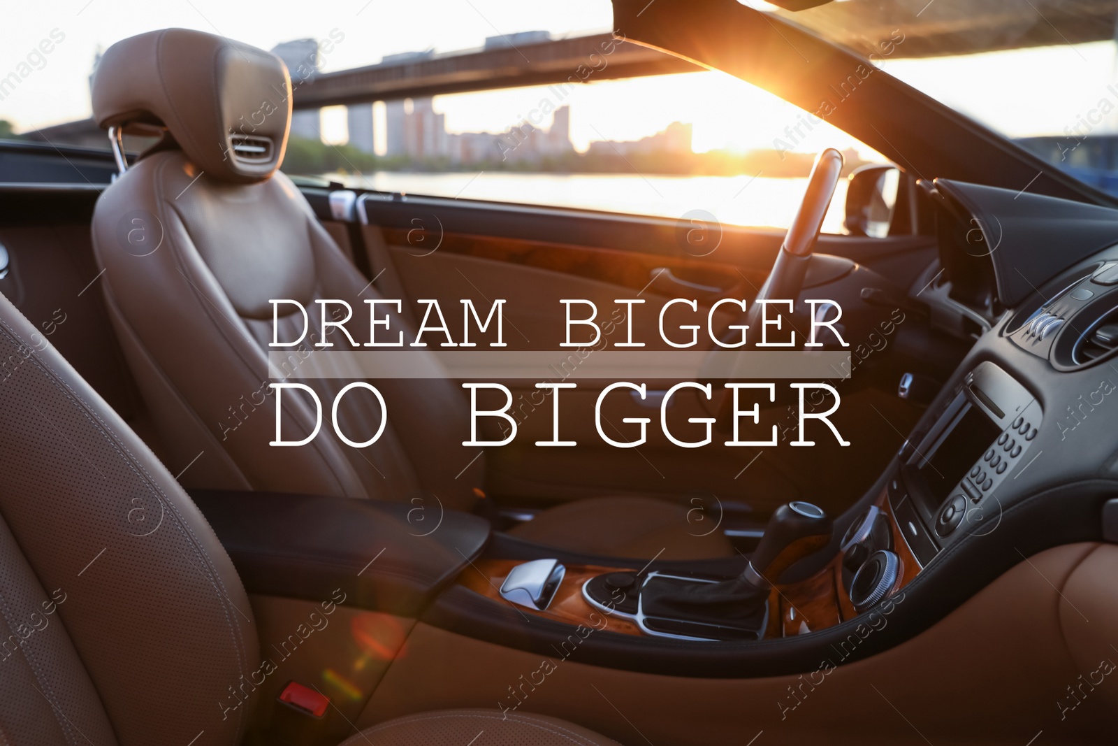 Image of Dream Bigger Do Bigger. Inspirational quote motivating to set life goals freely and forget about reasons that can hold back. Text against luxury car interior