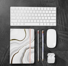 Photo of Flat lay composition with computer keyboard and notebook on grey background. Graphic designer's workplace