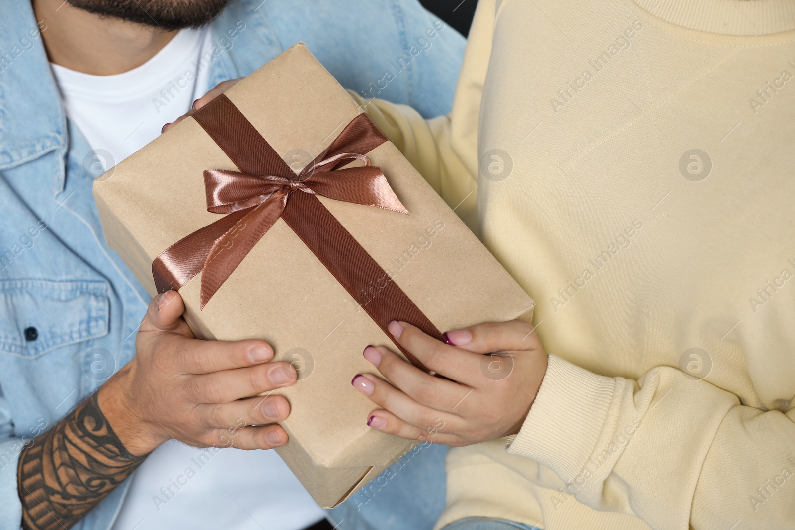 Photo of Lovely couple with beautiful gift, closeup view