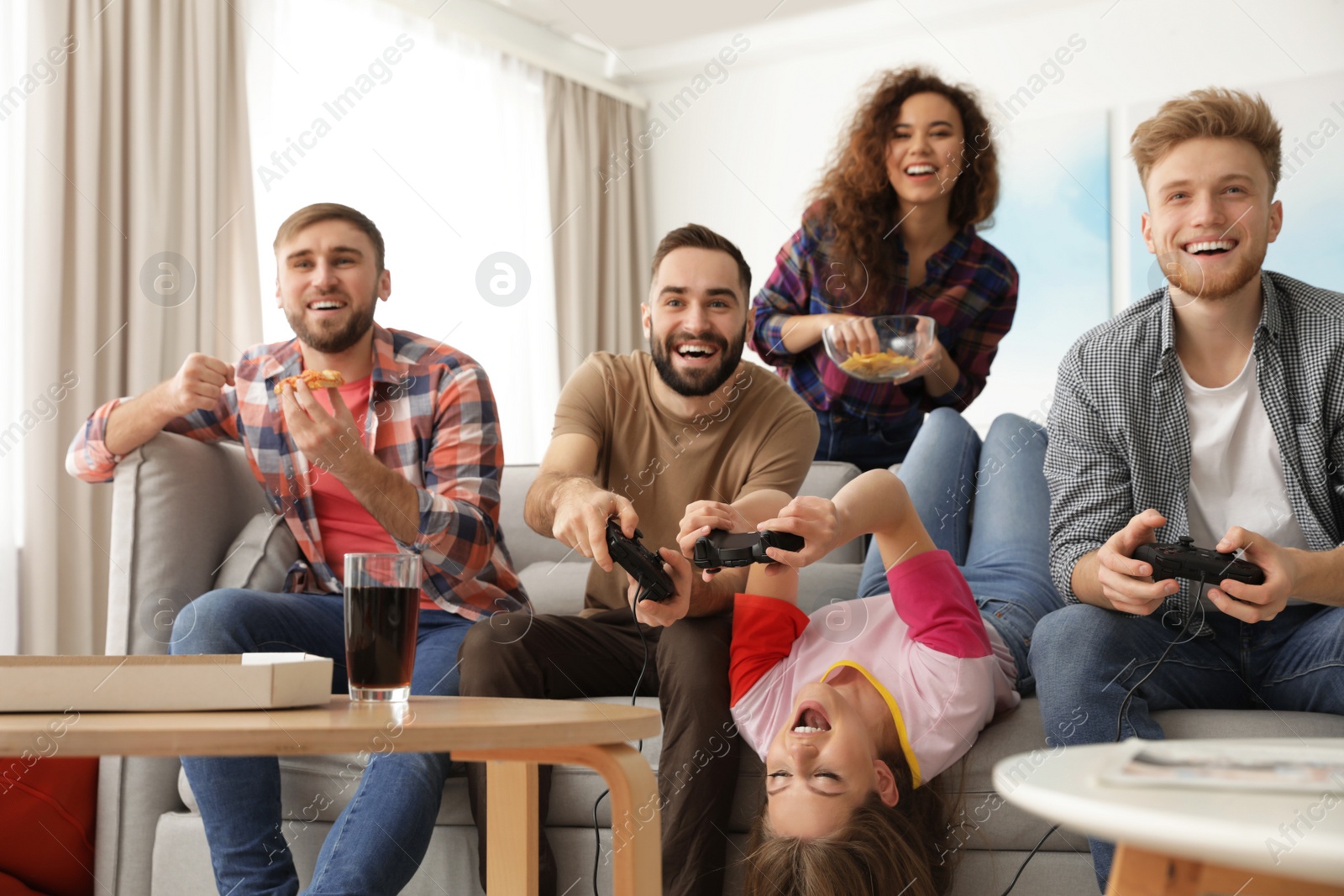 Photo of Emotional friends playing video games at home