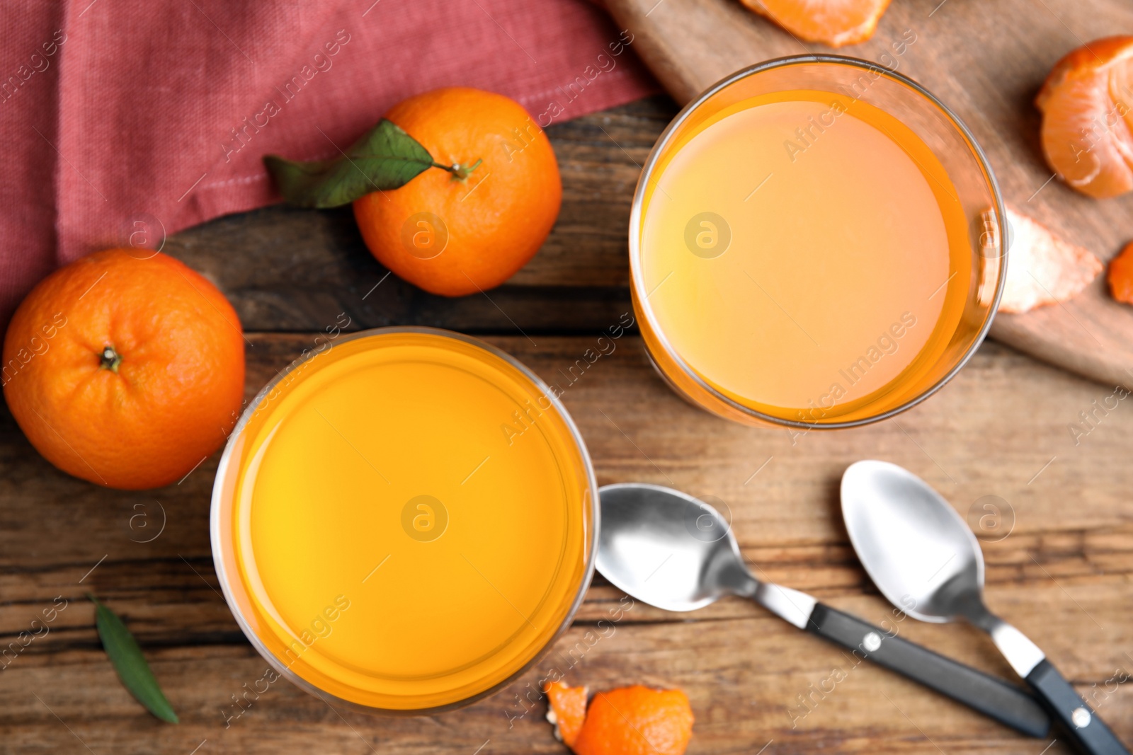 Photo of Delicious tangerine jelly and fresh fruits on wooden table, flat lay