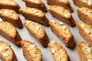 Photo of Traditional Italian almond biscuits (Cantucci) on light table, closeup