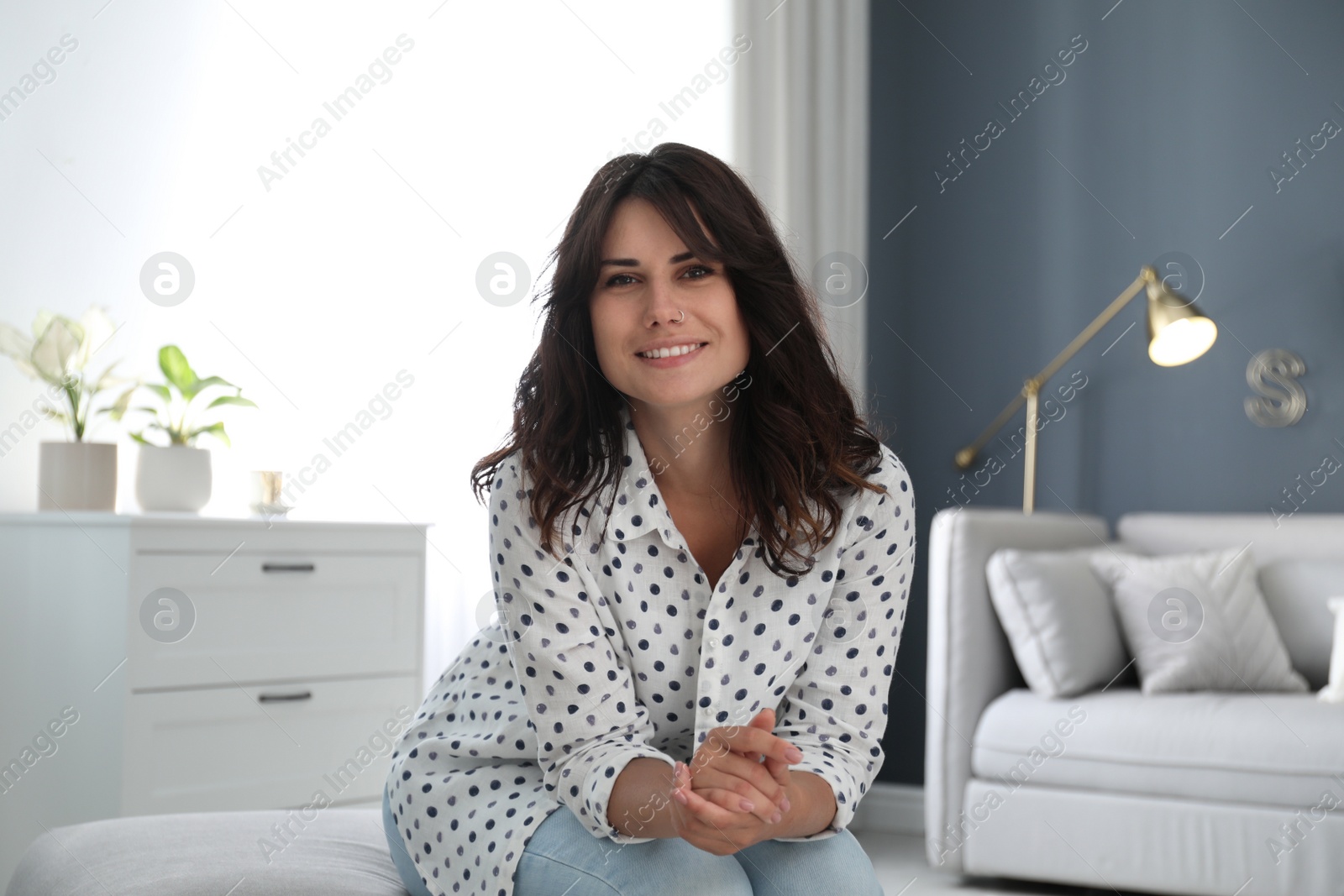 Photo of Young woman talking to her coworkers through video conference indoors, view from webcam