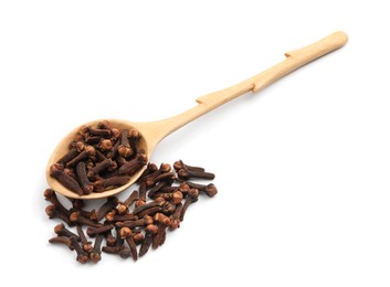 Pile of aromatic dry cloves and wooden spoon on white background