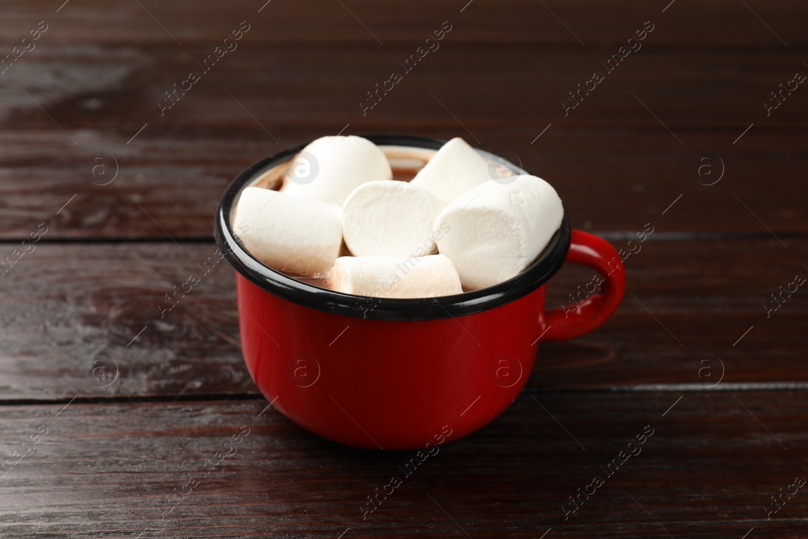 Photo of Tasty hot chocolate with marshmallows on wooden table