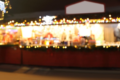 Blurred view of Christmas fair stalls outdoors at night