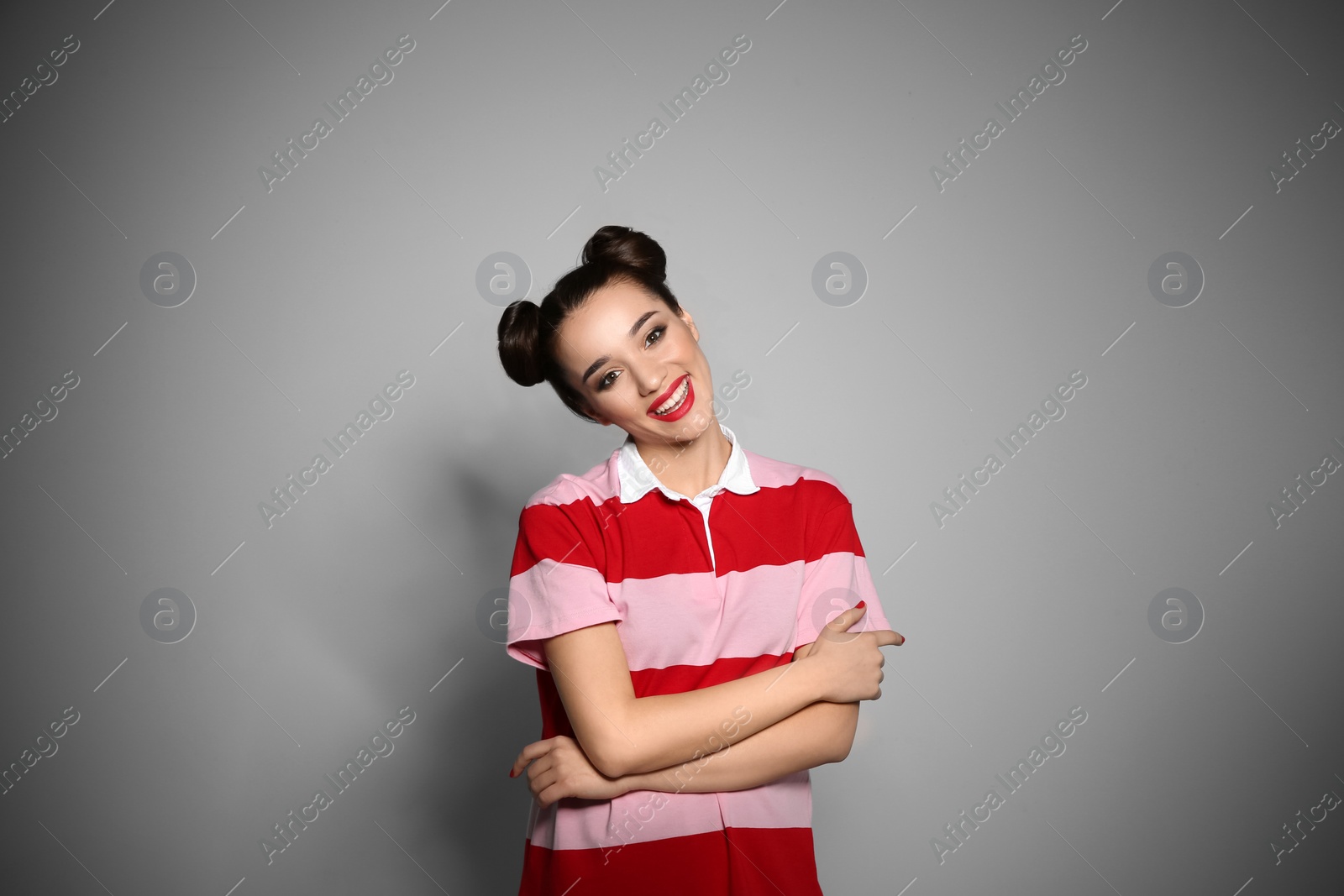 Photo of Portrait of beautiful young woman on grey background