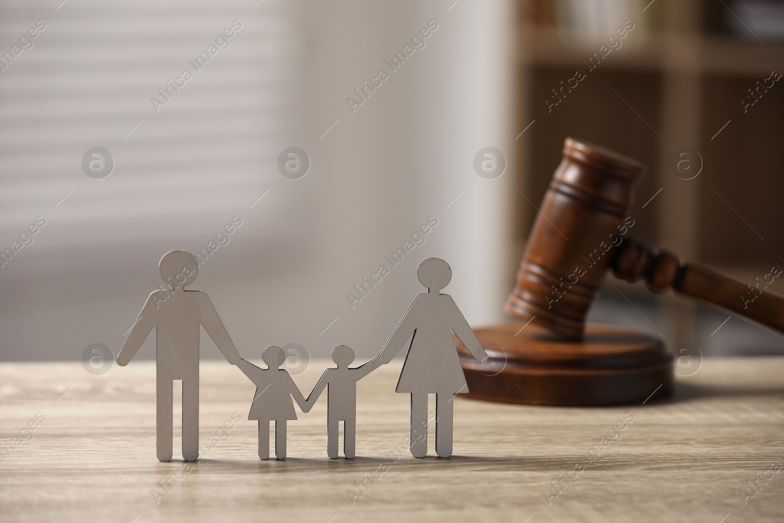 Photo of Family law. Figure of parents with children and gavel on wooden table, space for text