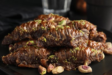 Delicious baklava with pistachio nuts on table, closeup