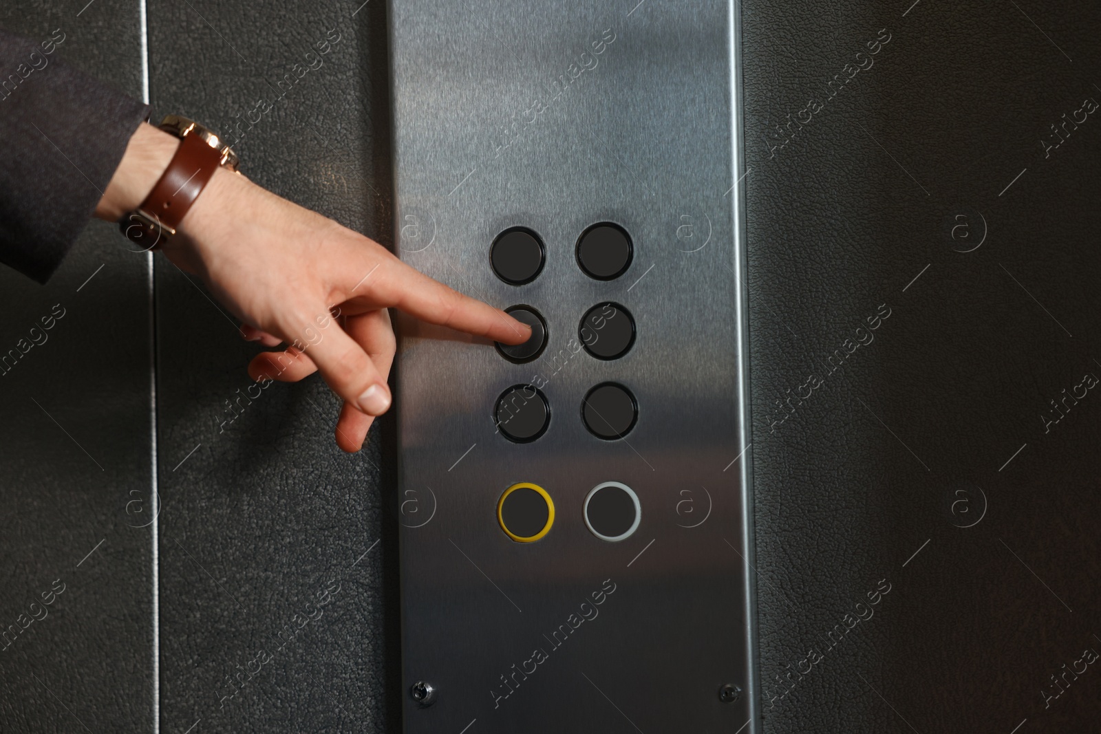 Photo of Man choosing floor in elevator, closeup view