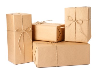 Parcels wrapped with kraft paper and twine on white background