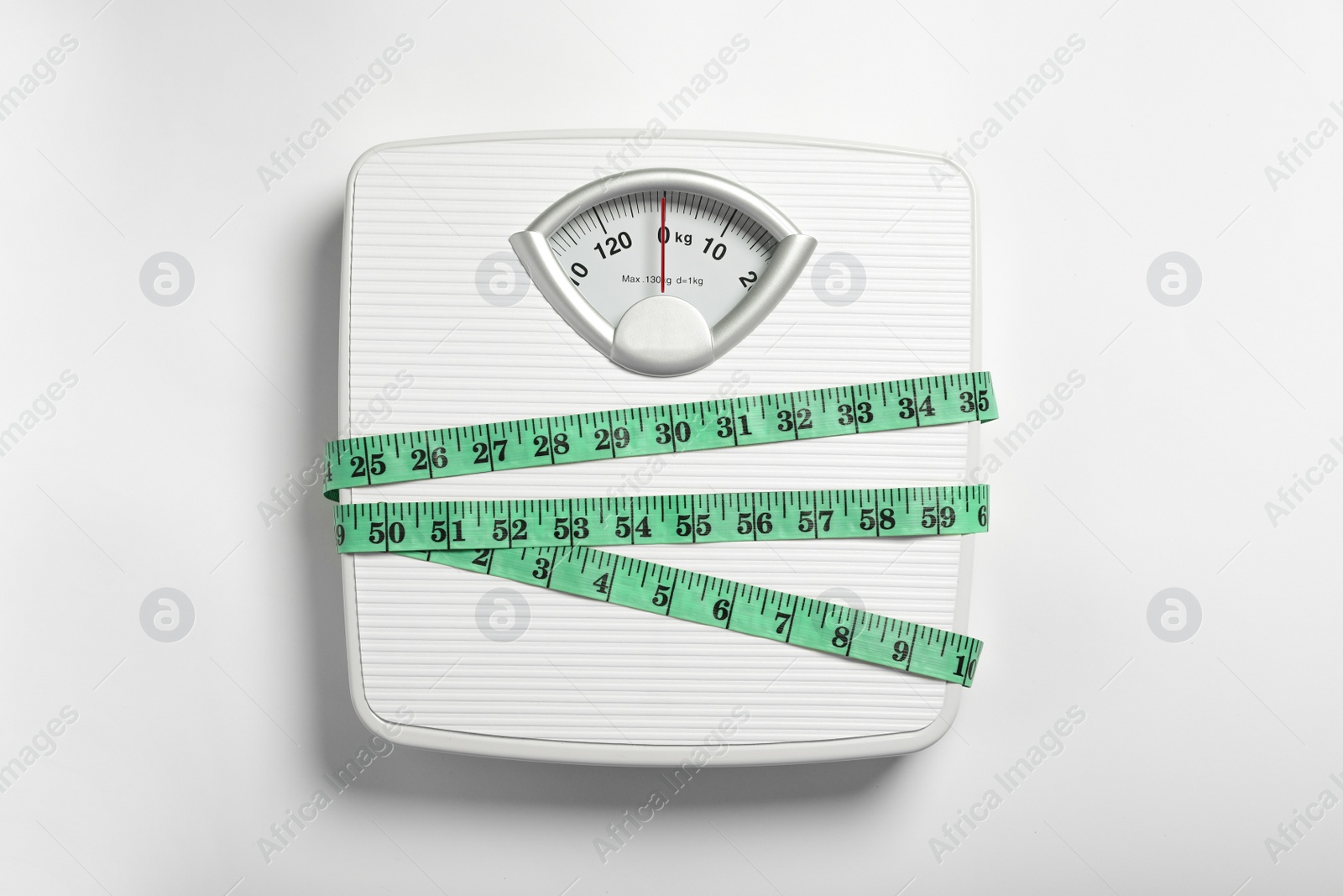 Photo of Weight loss concept. Scales and measuring tape on white background, top view