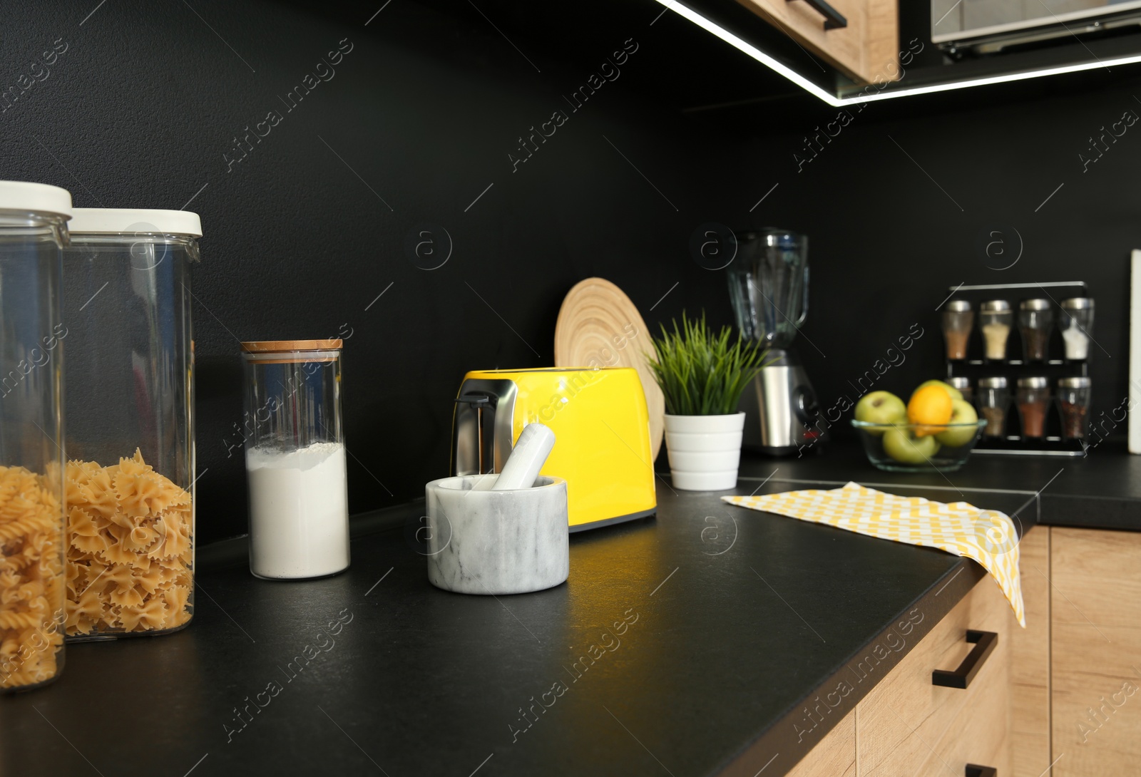 Photo of Stylish kitchen counter with houseware, appliances and products