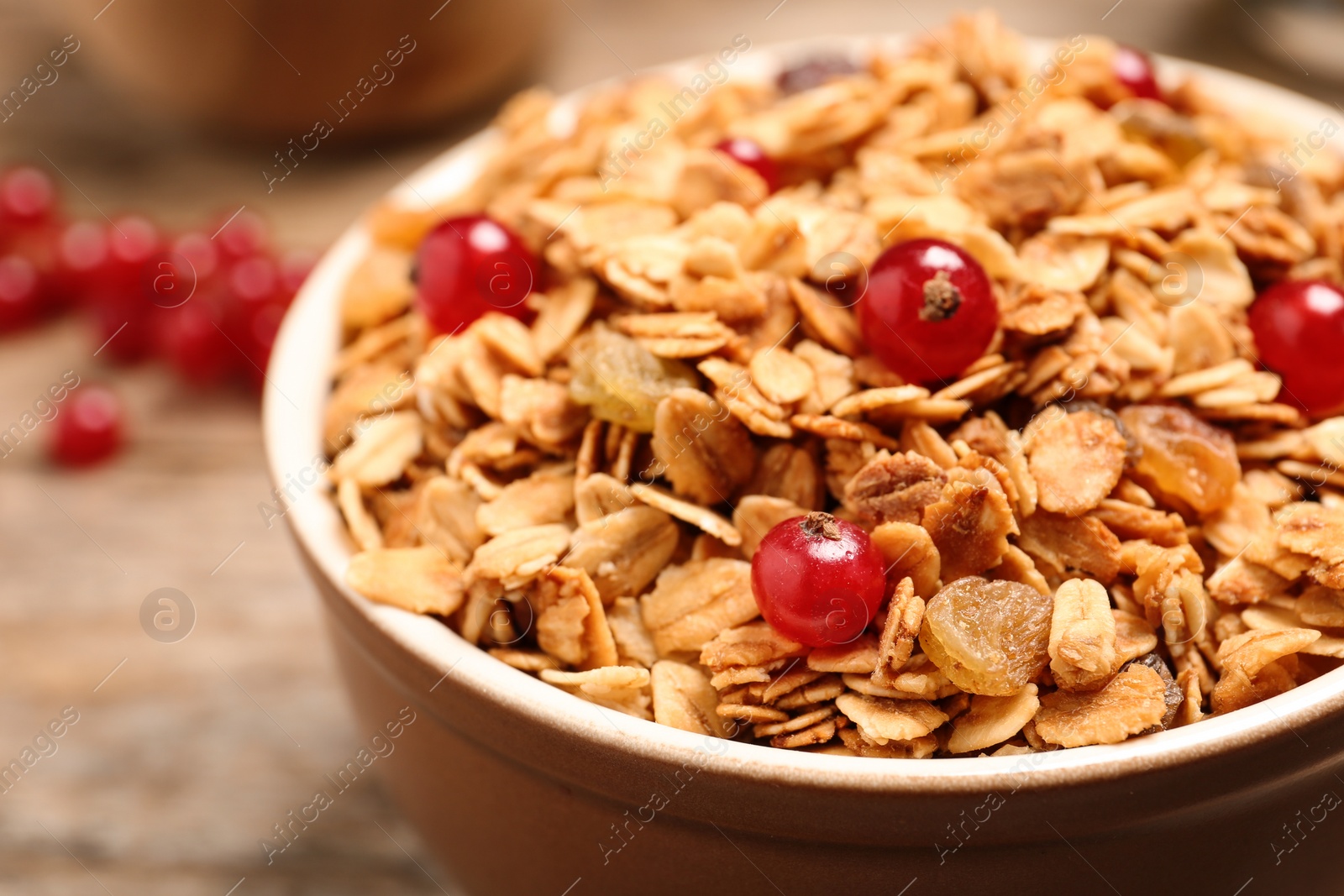 Photo of Muesli with berries in bowl, closeup. Delicious breakfast