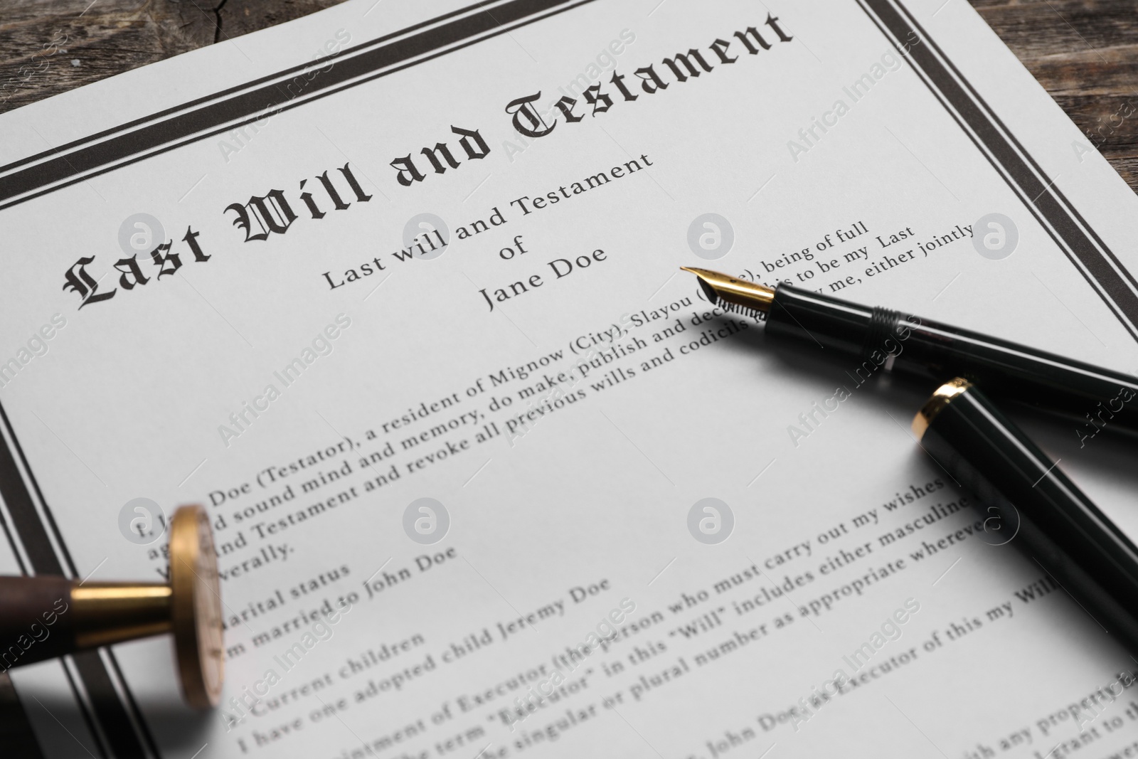 Photo of Last Will and Testament with wax stamp and fountain pen on table, closeup