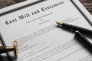 Photo of Last Will and Testament with wax stamp and fountain pen on table, closeup