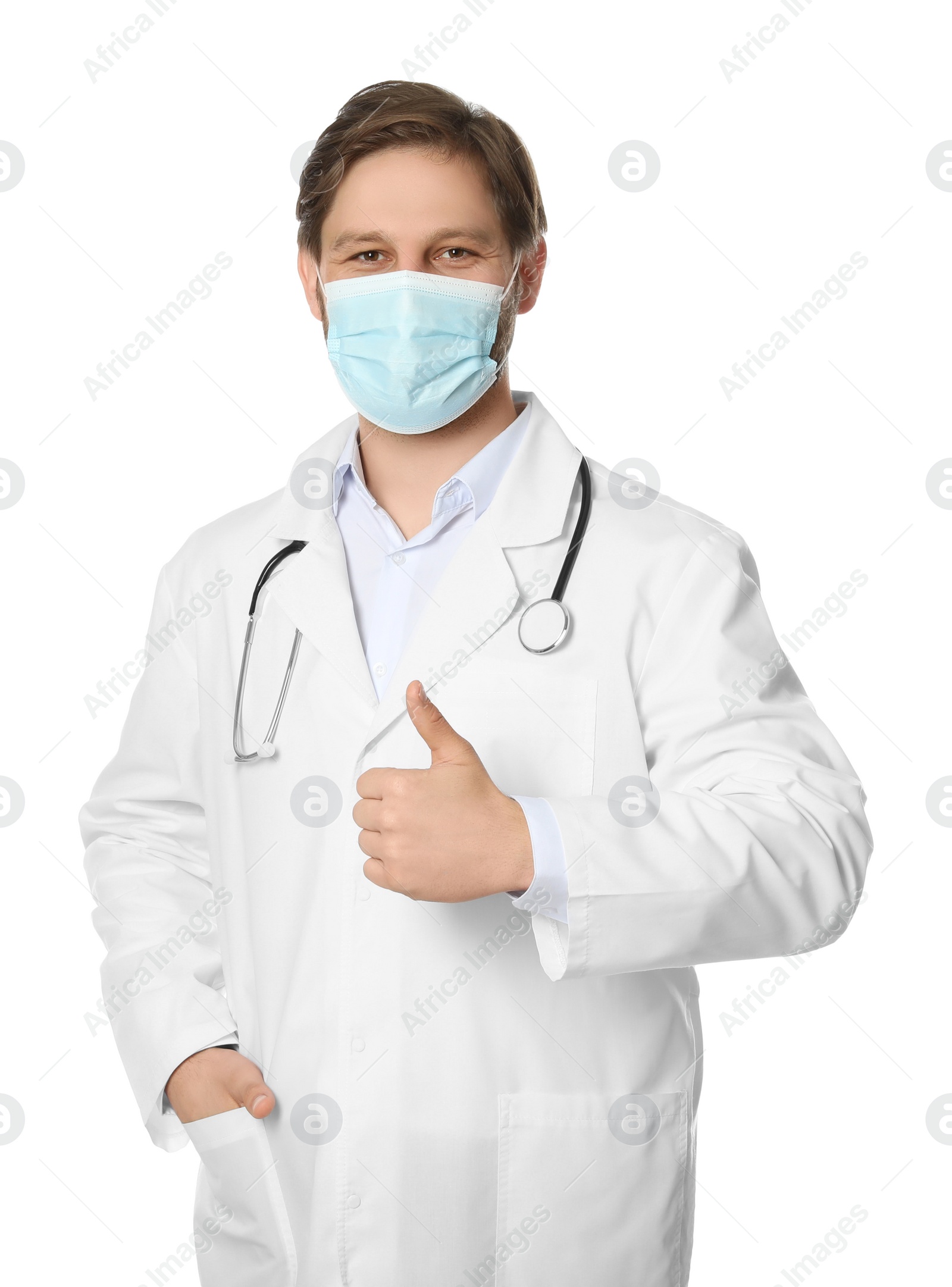 Photo of Doctor or medical assistant (male nurse) with protective mask and stethoscope showing thumb up on white background