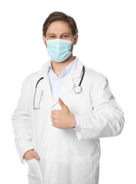Photo of Doctor or medical assistant (male nurse) with protective mask and stethoscope showing thumb up on white background