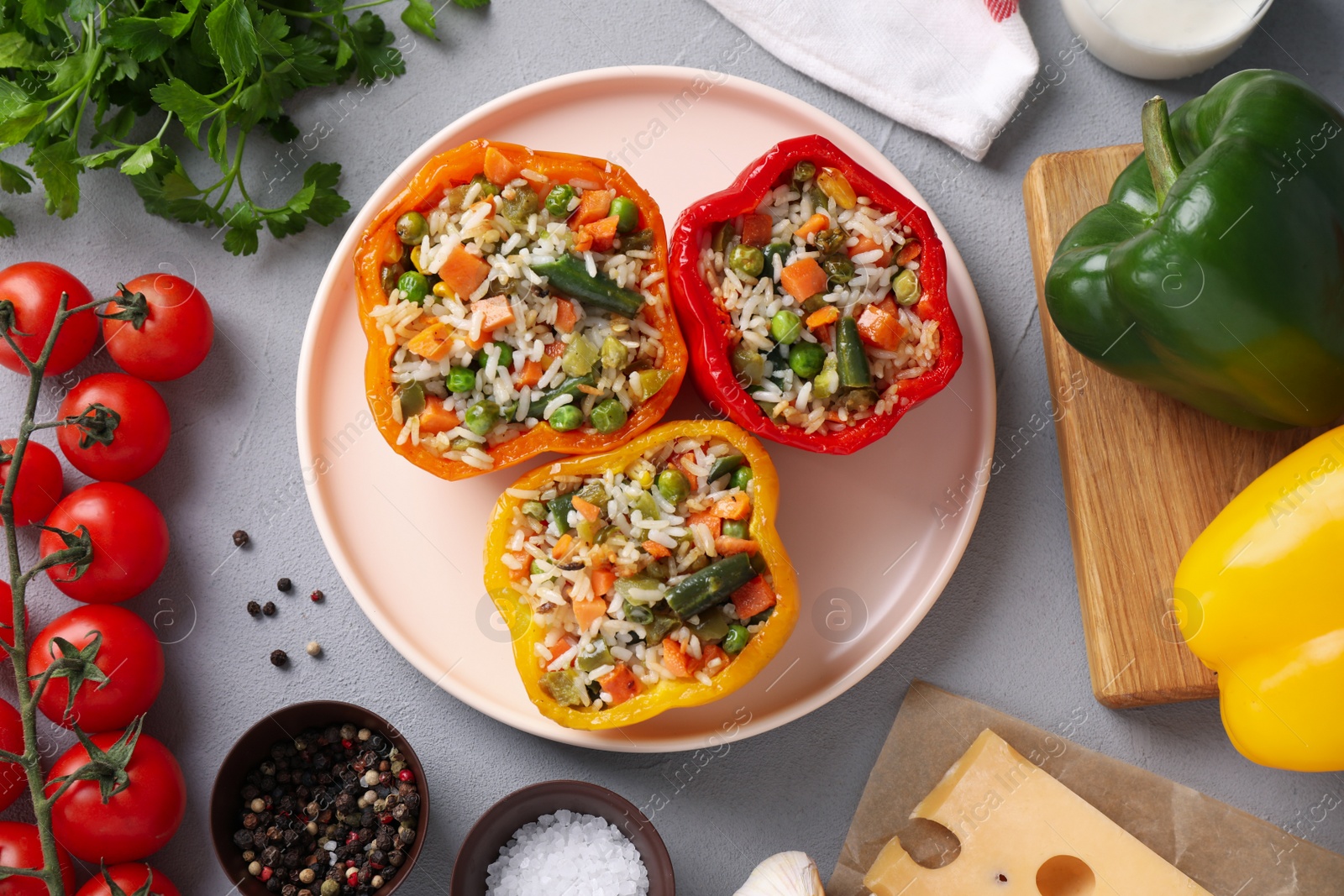 Photo of Flat lay composition with tasty stuffed bell peppers on grey table