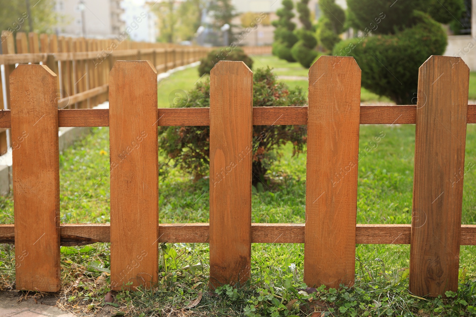 Photo of Small wooden fence on sunny day outdoors