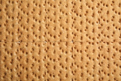 Fresh rye crispbreads as background, top view