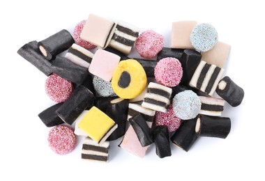 Many tasty liquorice candies isolated on white, top view