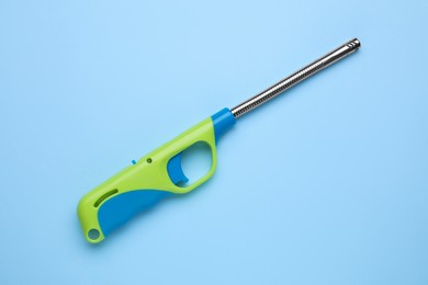 One gas lighter on light blue background, top view