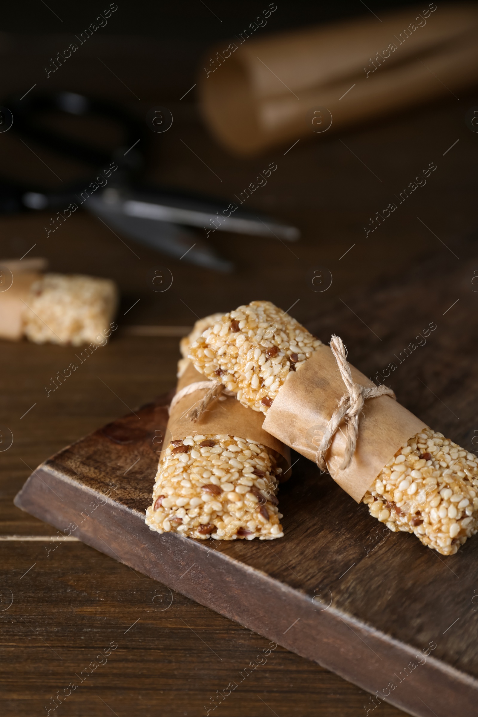 Photo of Tasty sesame seed bars on wooden table