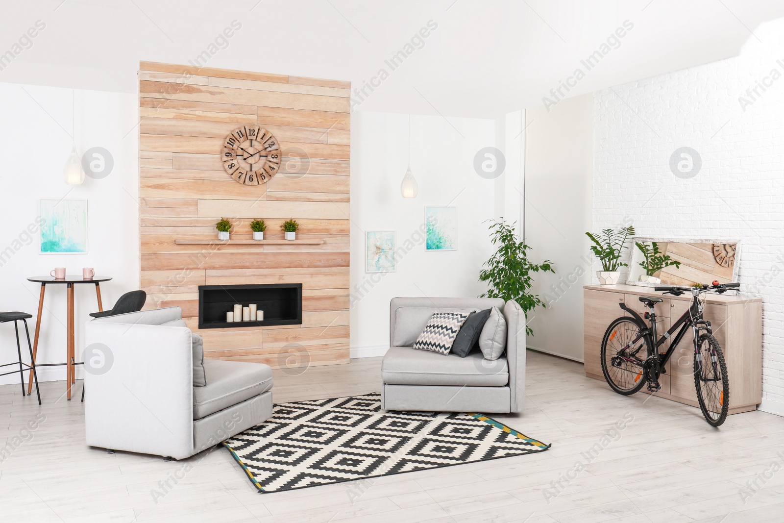 Photo of Bicycle near wooden chest of drawers in stylish room interior