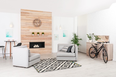 Photo of Bicycle near wooden chest of drawers in stylish room interior