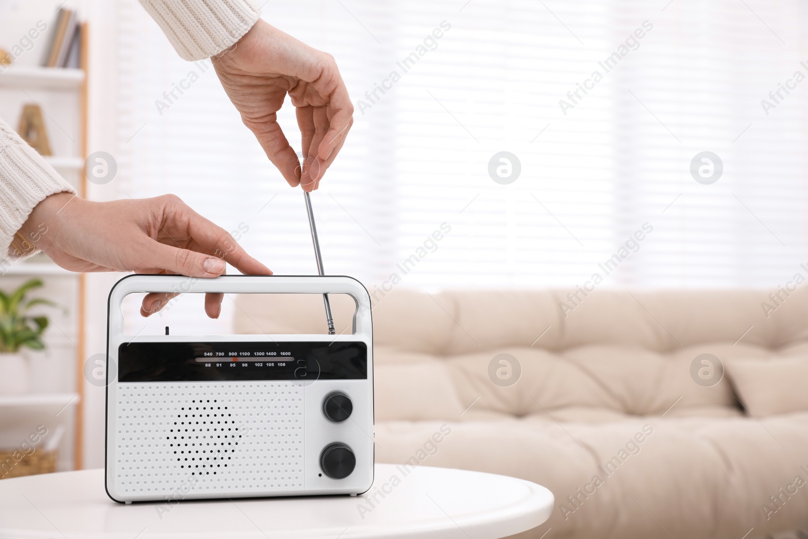 Photo of Woman adjusting radio antenna at home, closeup. Space for text