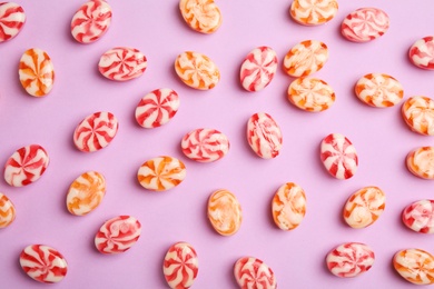 Photo of Flat lay composition with delicious colorful candies on color background