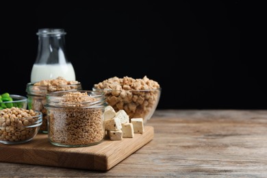 Photo of Different organic soy products on wooden table, space for text