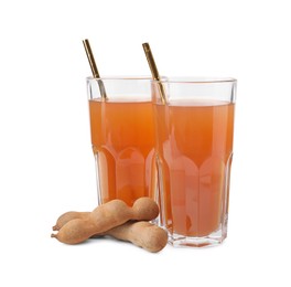 Glasses of tamarind juice and fresh fruits isolated on white