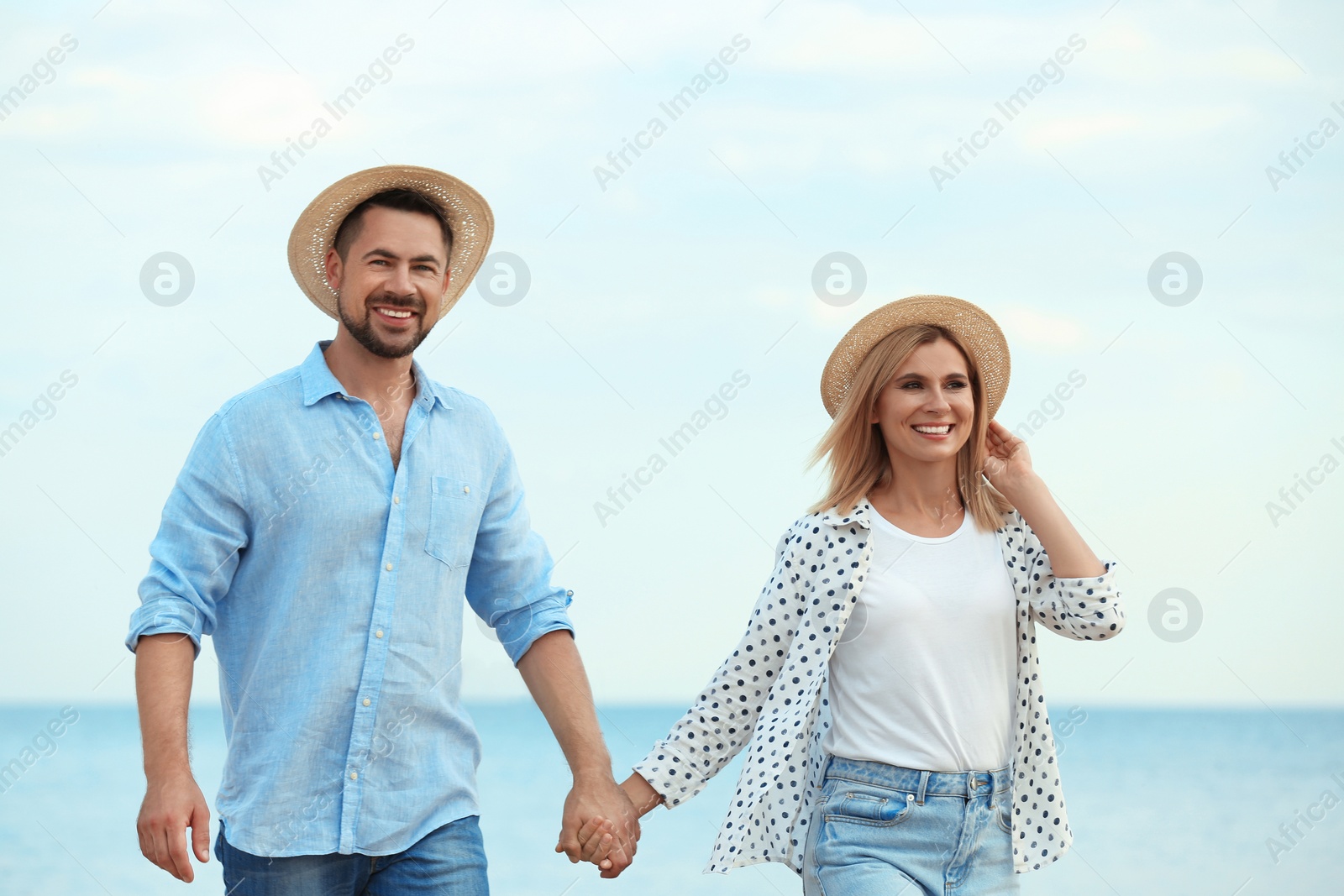 Photo of Happy romantic couple walking on beach, space for text