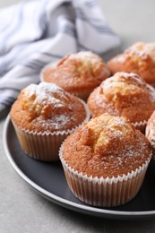 Photo of Delicious sweet muffins on light grey table, closeup