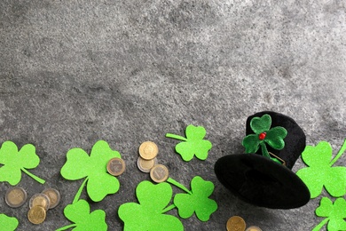 Photo of Leprechaun's hat and St. Patrick's day decor on grey stone background, flat lay. Space for text