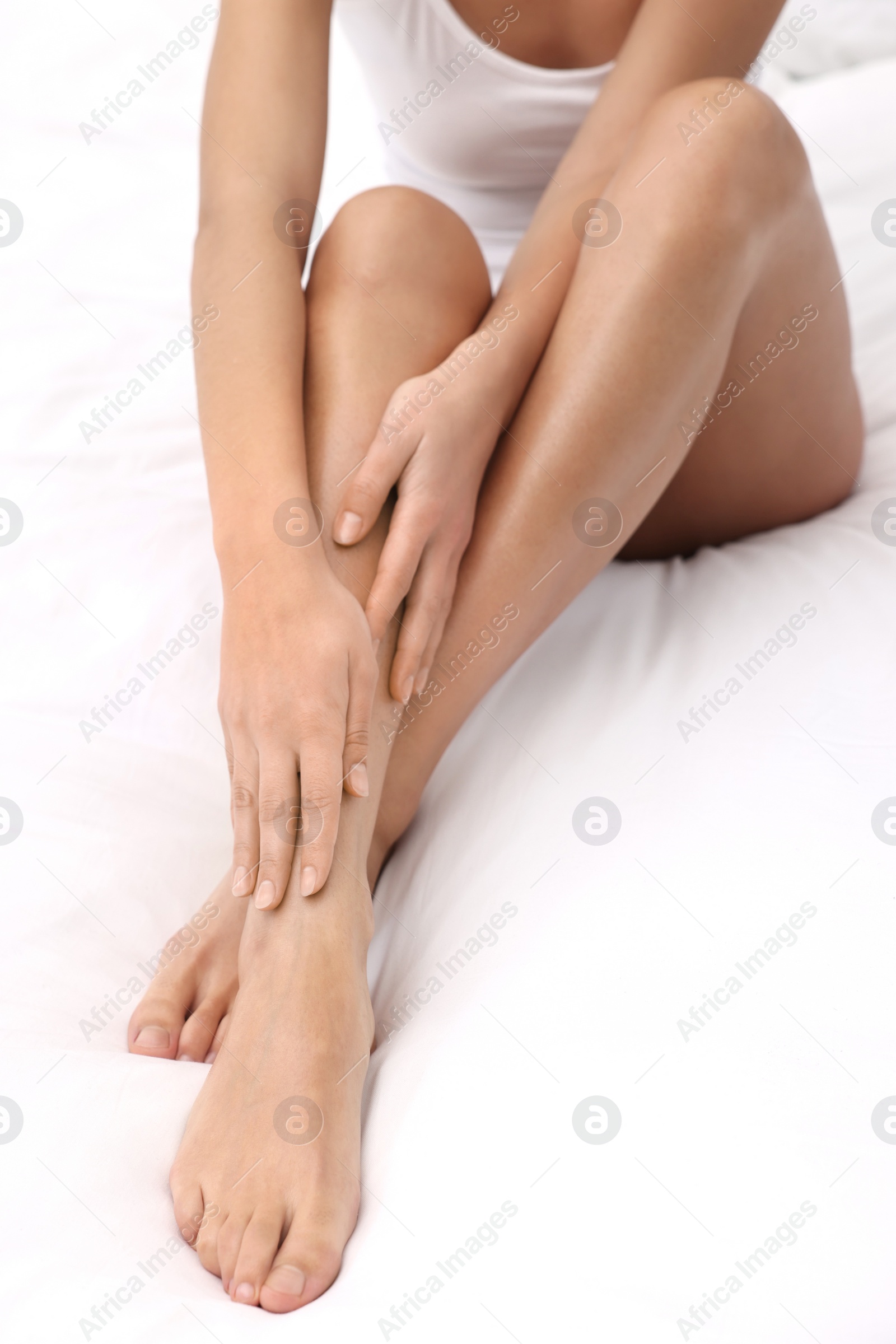 Photo of Woman with beautiful legs in bed, closeup