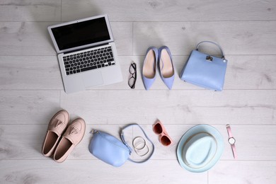 Flat lay composition of business items with vacation accessories on white wooden background. Life and work balance concept