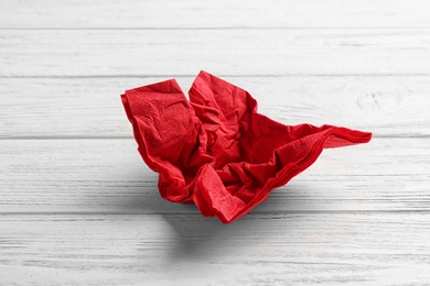 Crumpled napkin on wooden background. Personal hygiene